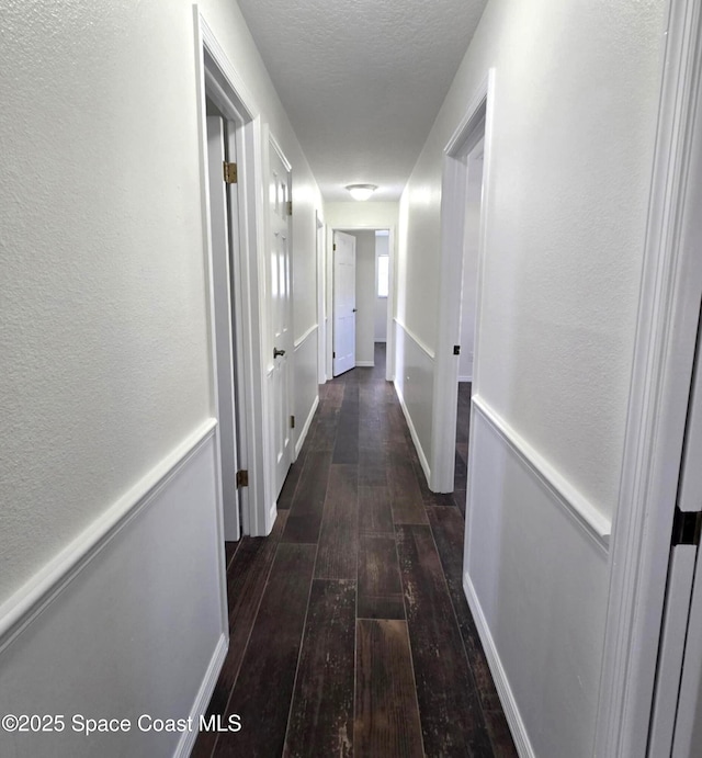 5215 Pina Vista Dr, Melbourne, FL 32934 - hallway with hardwood / wood-style floors, a textured ceiling, and a textured wall
