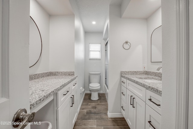 5215 Pina Vista Dr, Melbourne, FL 32934 - full bathroom featuring vanity, combined bath / shower with glass door, toilet, wood finished floors, and recessed lighting