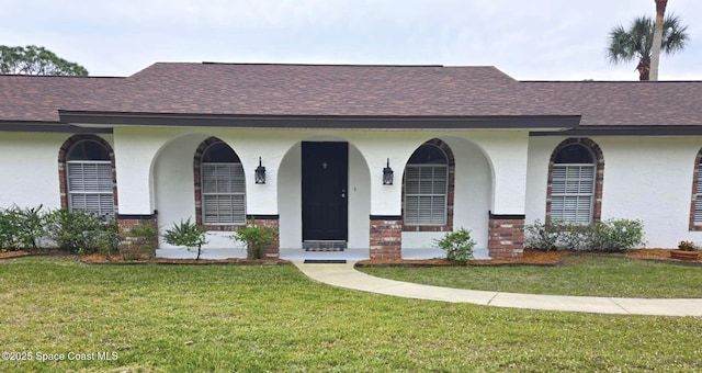 5215 Pina Vista Dr, Melbourne, FL 32934 - view of front of house with a shingled roof, stucco siding, and a front yard