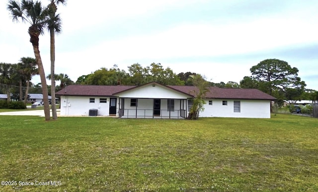 5215 Pina Vista Dr, Melbourne, FL 32934 - view of front of house with a front yard and central AC unit