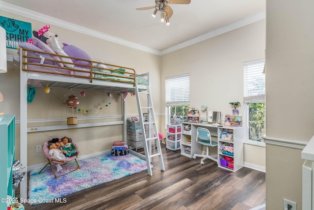 bedroom with baseboards, multiple windows, ornamental molding, and wood finished floors