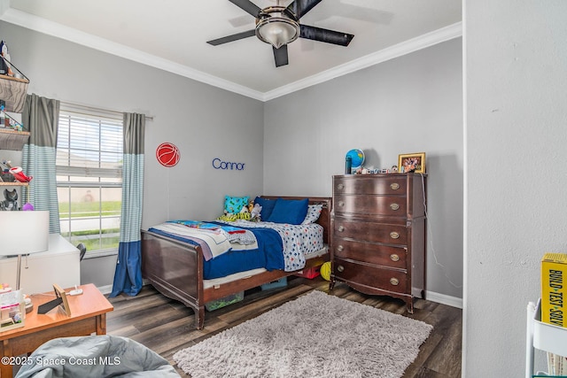 bedroom with baseboards, ornamental molding, a ceiling fan, and wood finished floors