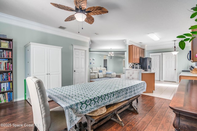 dining area featuring crown molding, a ceiling fan, and hardwood / wood-style flooring