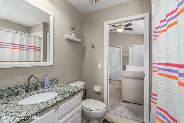 full bath with vanity, vaulted ceiling, toilet, visible vents, and ceiling fan