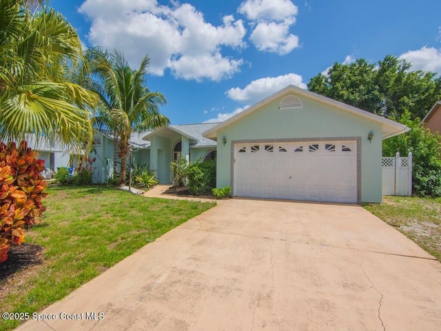 344 Concha Dr, Sebastian, FL 32958 - single story home featuring a front yard, a garage, concrete driveway, fence, and stucco siding
