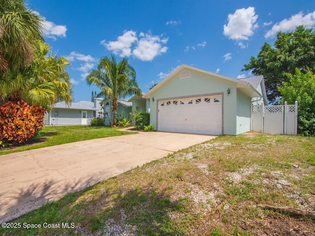 344 Concha Dr, Sebastian, FL 32958 - single story home featuring stucco siding, a front yard, fence, an attached garage, and concrete driveway