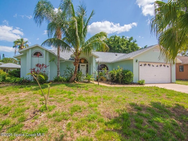 344 Concha Dr, Sebastian, FL 32958 - view of front facade featuring concrete driveway, a front lawn, a garage, and stucco siding