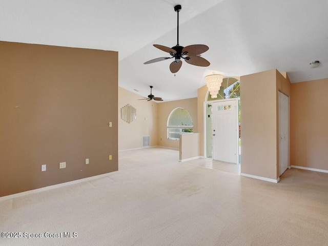 344 Concha Dr, Sebastian, FL 32958 - unfurnished living room featuring light carpet, baseboards, a ceiling fan, and lofted ceiling