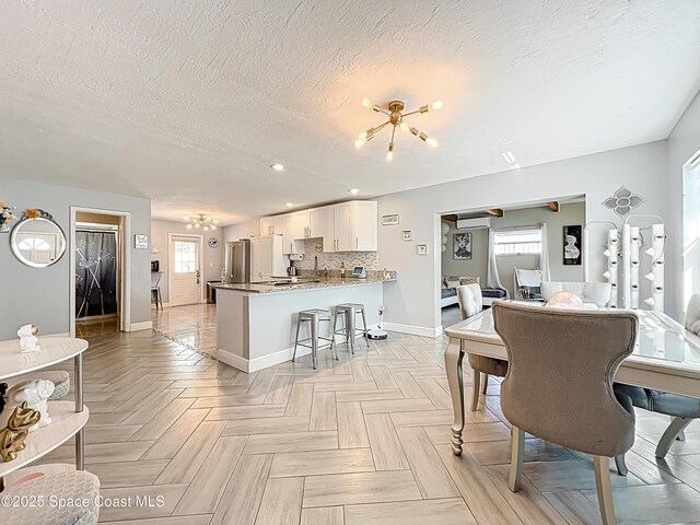 1760 Tee Dee Ln, Titusville, FL 32780 - interior space featuring recessed lighting, a notable chandelier, baseboards, and a textured ceiling