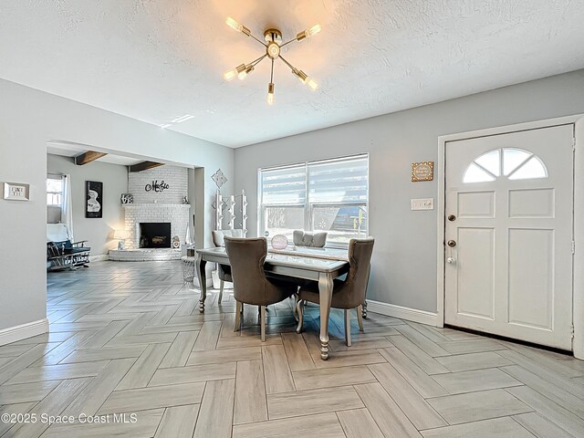 1760 Tee Dee Ln, Titusville, FL 32780 - dining space with a textured ceiling, baseboards, and a brick fireplace
