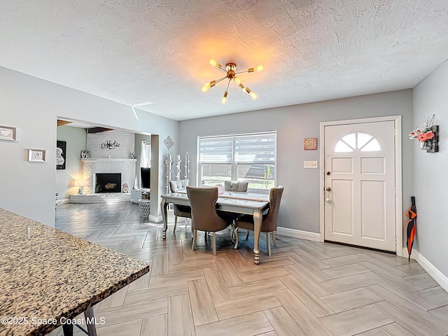 1760 Tee Dee Ln, Titusville, FL 32780 - dining room with baseboards, a textured ceiling, and a fireplace