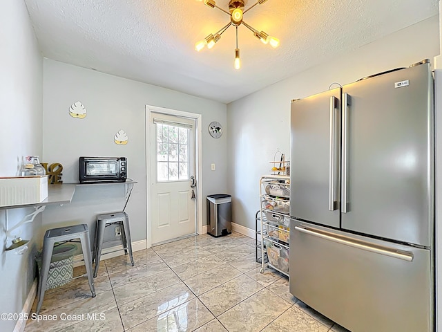 1760 Tee Dee Ln, Titusville, FL 32780 - kitchen with baseboards, a toaster, high end refrigerator, and a textured ceiling