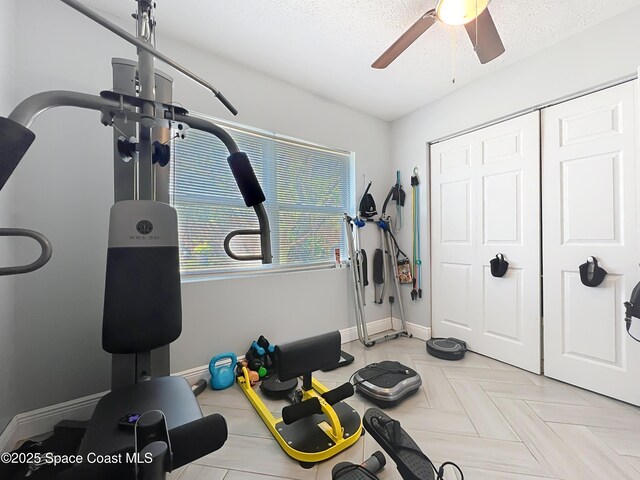 1760 Tee Dee Ln, Titusville, FL 32780 - exercise room featuring baseboards, ceiling fan, and a textured ceiling