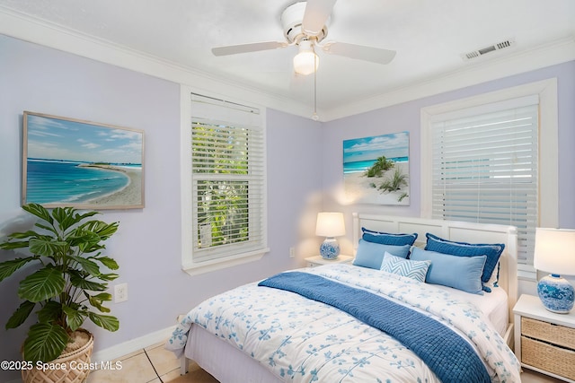 bedroom with a ceiling fan, tile patterned floors, crown molding, and visible vents
