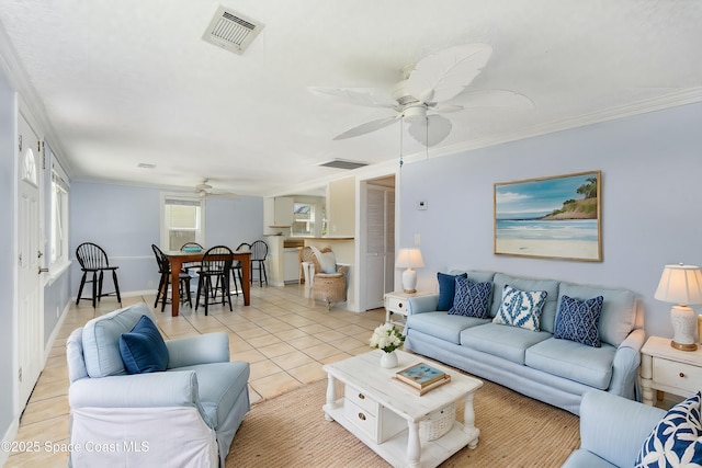 living room with a ceiling fan, light tile patterned flooring, ornamental molding, and visible vents