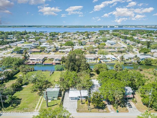 drone / aerial view featuring a residential view and a water view