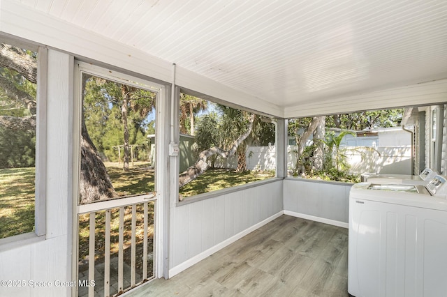 unfurnished sunroom with washer and clothes dryer