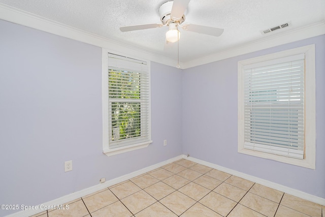 spare room with crown molding, a ceiling fan, a textured ceiling, light tile patterned floors, and visible vents