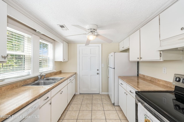 kitchen with light countertops, white appliances, a sink, ceiling fan, and white cabinets