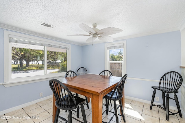 dining area with light tile patterned floors, ornamental molding, visible vents, and a ceiling fan