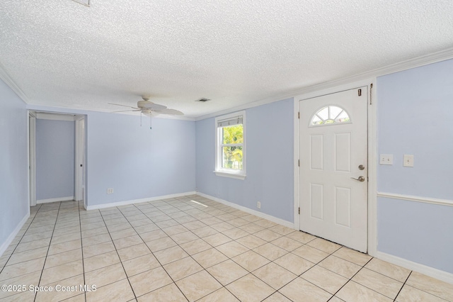 foyer featuring a ceiling fan, ornamental molding, baseboards, and a textured ceiling