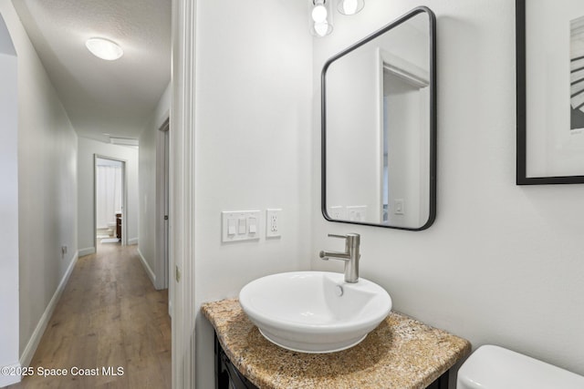 2702 Barrow Dr, Merritt Island, FL 32952 - bathroom featuring toilet, vanity, baseboards, and wood finished floors