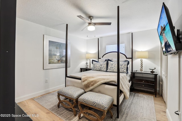 2702 Barrow Dr, Merritt Island, FL 32952 - bedroom with baseboards, a textured ceiling, and light wood-type flooring
