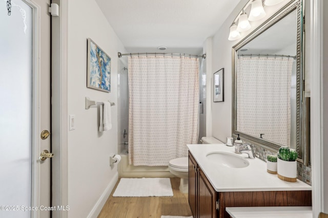 2702 Barrow Dr, Merritt Island, FL 32952 - bathroom with toilet, vanity, shower / tub combo, and wood finished floors