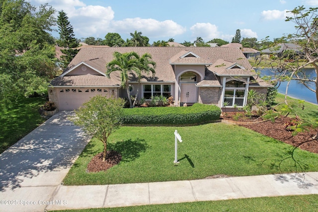 2702 Barrow Dr, Merritt Island, FL 32952 - view of front facade featuring driveway, a garage, a front lawn, and roof with shingles