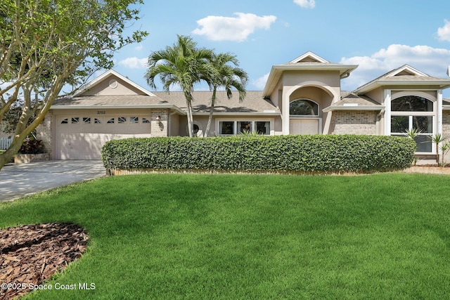 2702 Barrow Dr, Merritt Island, FL 32952 - ranch-style home with an attached garage, roof with shingles, concrete driveway, and a front yard
