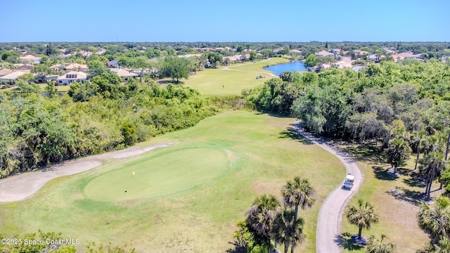 birds eye view of property with view of golf course, a water view, and a residential view