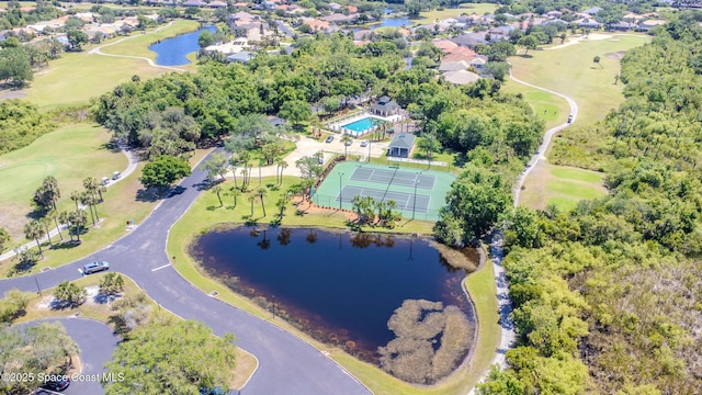drone / aerial view with view of golf course and a water view
