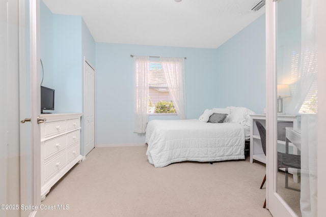 bedroom featuring visible vents, baseboards, and light carpet