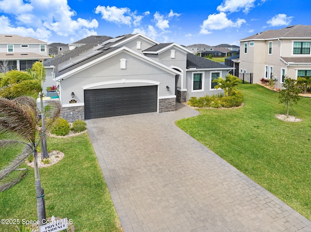 view of front of home featuring stucco siding, a residential view, decorative driveway, a front lawn, and a garage