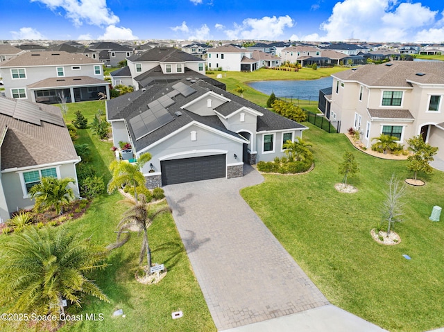 birds eye view of property with a residential view and a water view