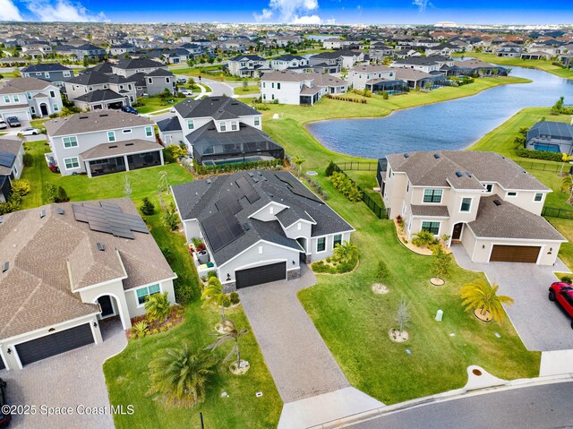 birds eye view of property with a residential view and a water view