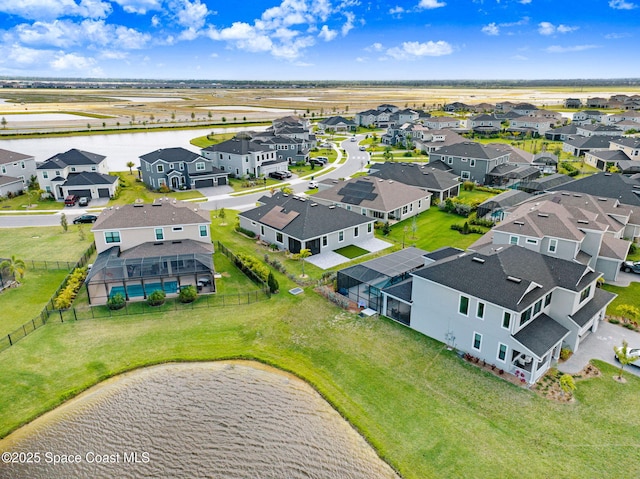 drone / aerial view featuring a residential view and a water view
