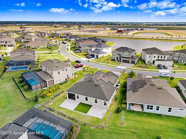 drone / aerial view featuring a residential view and a water view