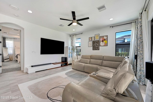 living area featuring light wood-style floors, ceiling fan, visible vents, and recessed lighting