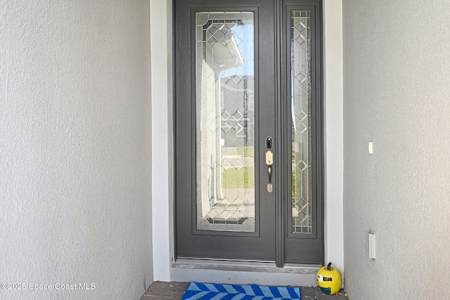 doorway to property with stucco siding