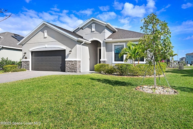 single story home featuring stone siding, driveway, a garage, a front yard, and stucco siding