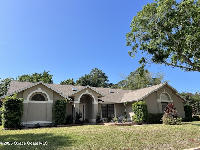 523 Hidden Hollow Dr, Merritt Island, FL 32952 - single story home with a front yard, stucco siding, and roof with shingles
