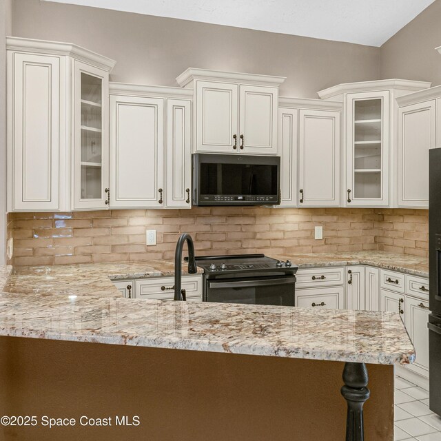 523 Hidden Hollow Dr, Merritt Island, FL 32952 - kitchen with black range with electric cooktop, light stone countertops, and tasteful backsplash