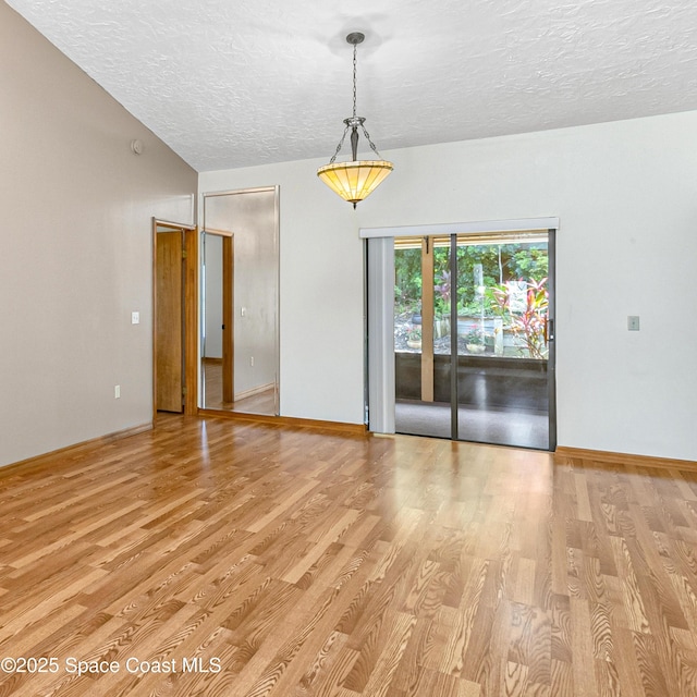 523 Hidden Hollow Dr, Merritt Island, FL 32952 - unfurnished room with baseboards, a textured ceiling, and light wood-style floors