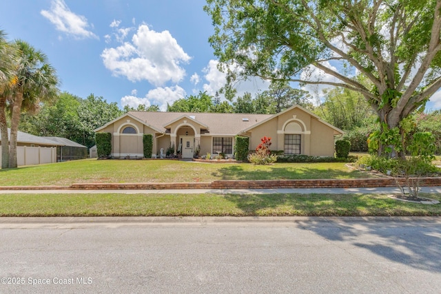 523 Hidden Hollow Dr, Merritt Island, FL 32952 - ranch-style home with a front lawn, stucco siding, and fence