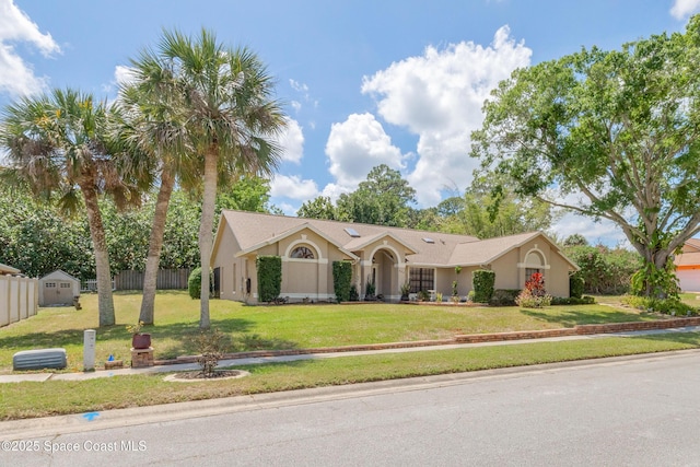 523 Hidden Hollow Dr, Merritt Island, FL 32952 - ranch-style house with a front lawn, stucco siding, and fence