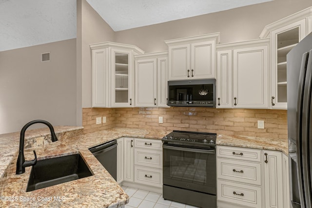 523 Hidden Hollow Dr, Merritt Island, FL 32952 - kitchen with tasteful backsplash, a sink, visible vents, light stone countertops, and appliances with stainless steel finishes