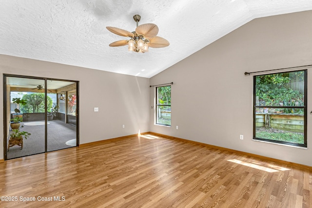 523 Hidden Hollow Dr, Merritt Island, FL 32952 - interior space featuring light wood finished floors, a textured ceiling, lofted ceiling, and a ceiling fan
