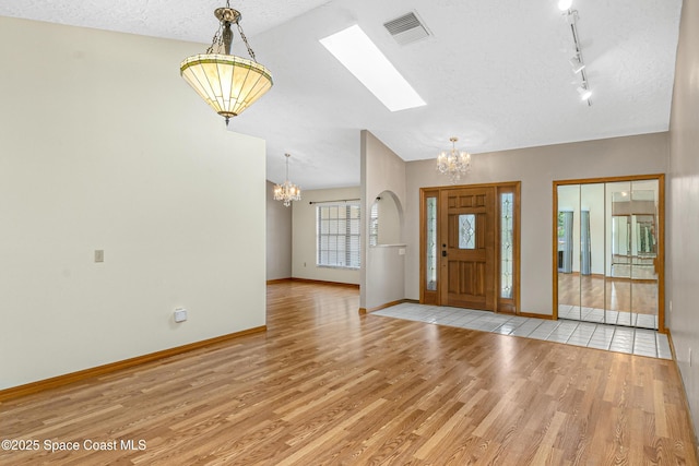 523 Hidden Hollow Dr, Merritt Island, FL 32952 - entryway featuring baseboards, a chandelier, a textured ceiling, visible vents, and wood finished floors