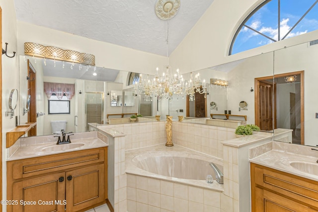 523 Hidden Hollow Dr, Merritt Island, FL 32952 - full bathroom featuring a garden tub, lofted ceiling, a sink, and a stall shower